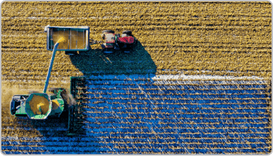 Aerial photo of a combine harvester harvesting a field